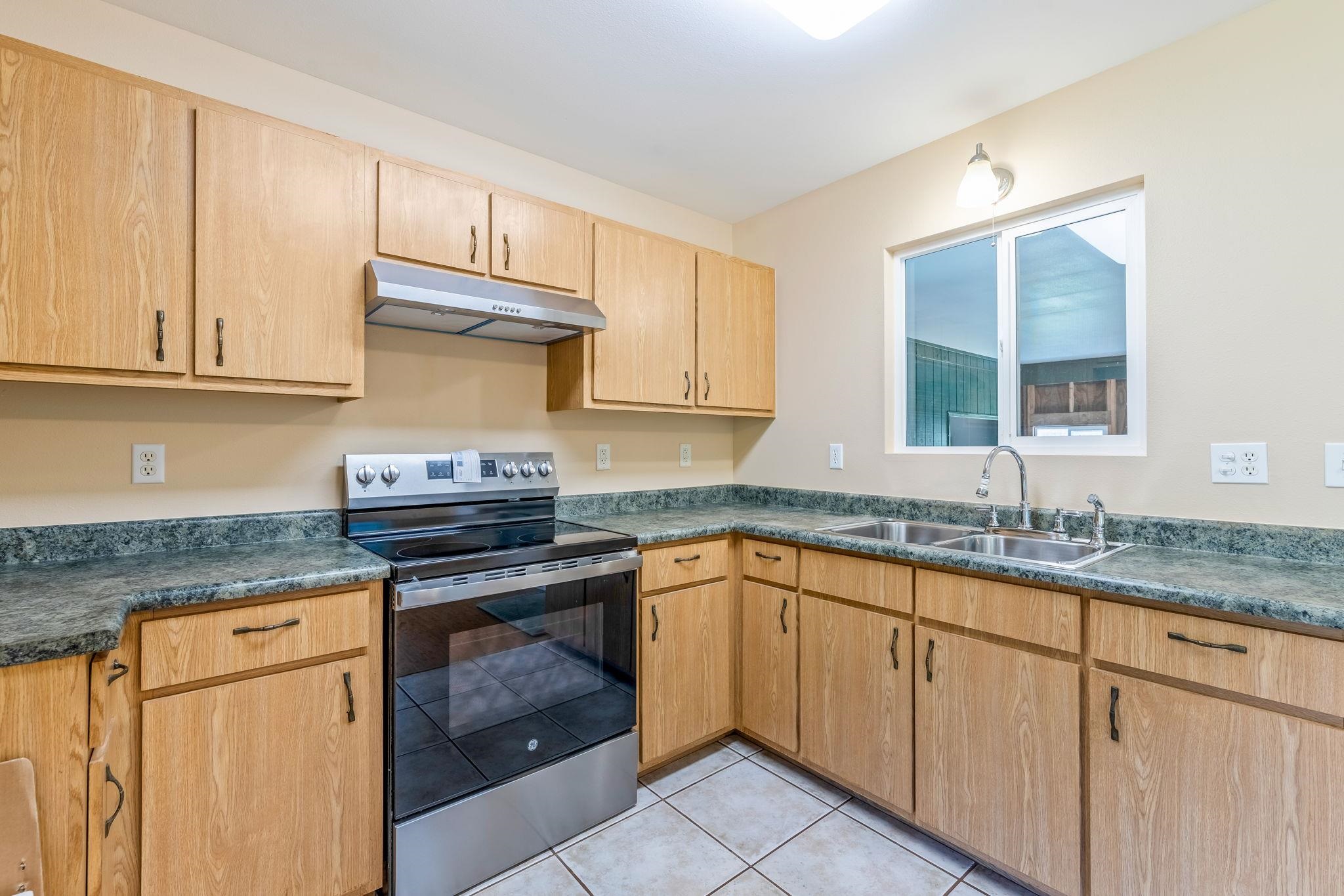 2640 Olinda Road Makawao, HI 96768 - Photo 27 of 49 a kitchen with granite countertop cabinets stainless steel appliances and a sink