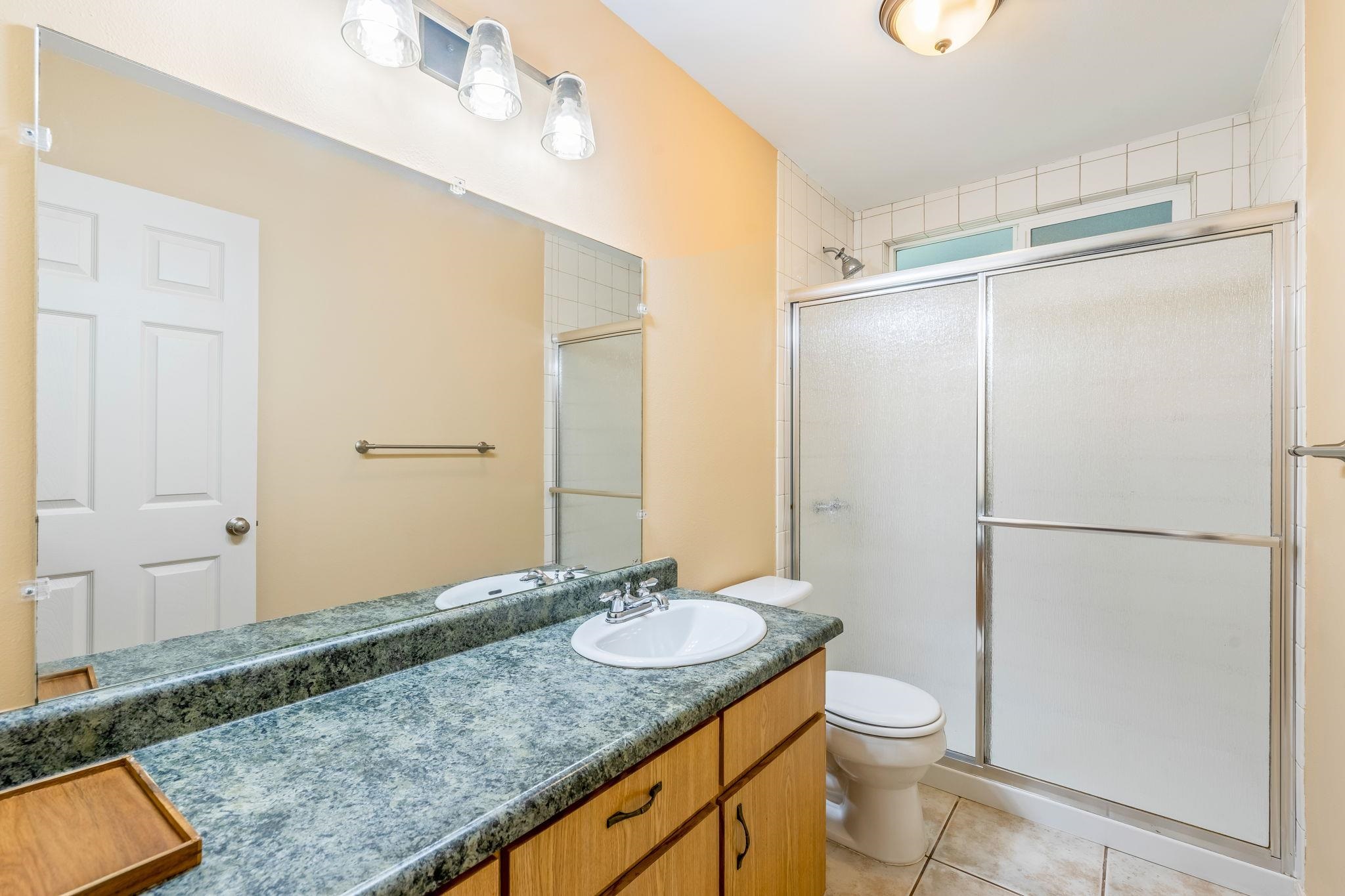 2640 Olinda Road Makawao, HI 96768 - Photo 31 of 49 a bathroom with a granite countertop sink toilet and shower