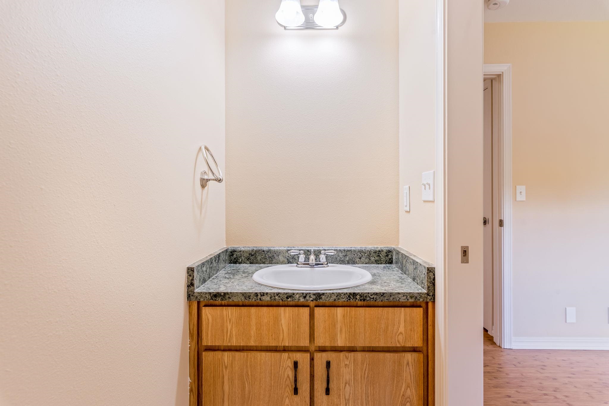 2640 Olinda Road Makawao, HI 96768 - Photo 33 of 49 a bathroom with a granite countertop sink and a mirror