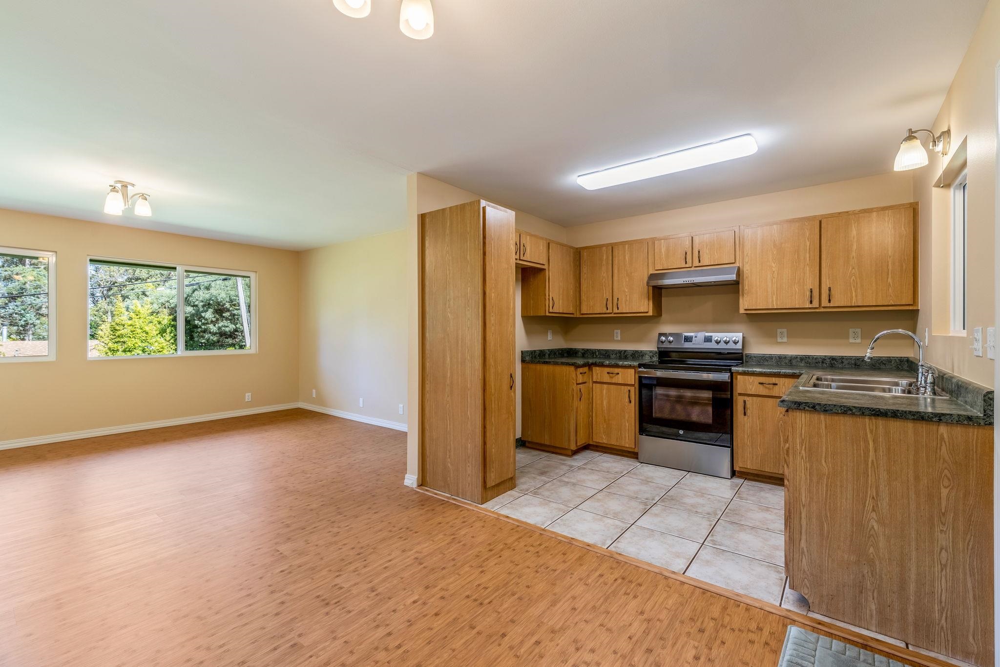 2640 Olinda Road Makawao, HI 96768 - Photo 34 of 49 a kitchen with granite countertop a stove cabinets and refrigerator