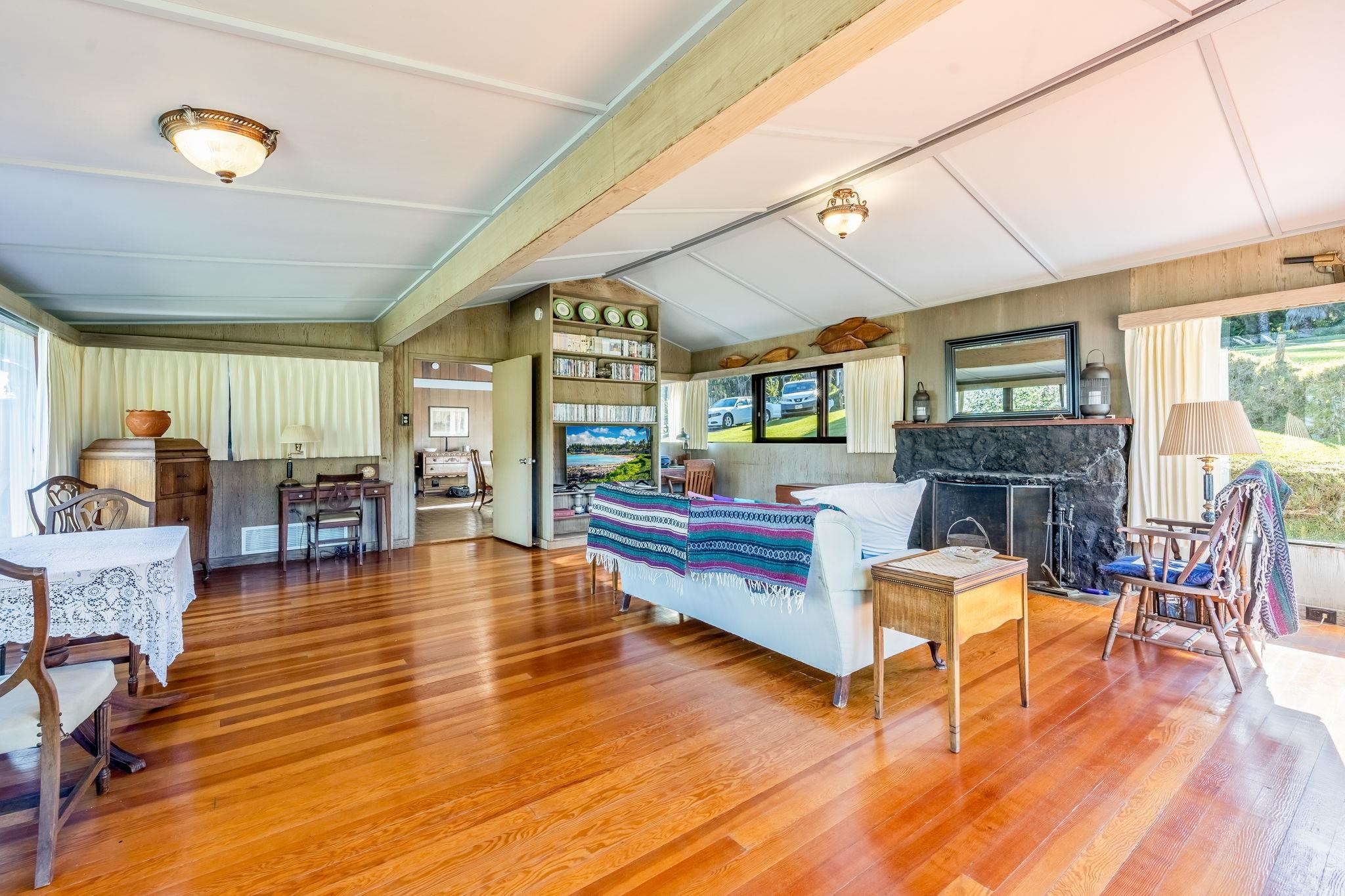 2640 Olinda Road Makawao, HI 96768 - Photo 46 of 49 a living room with fireplace furniture wooden floor and a table