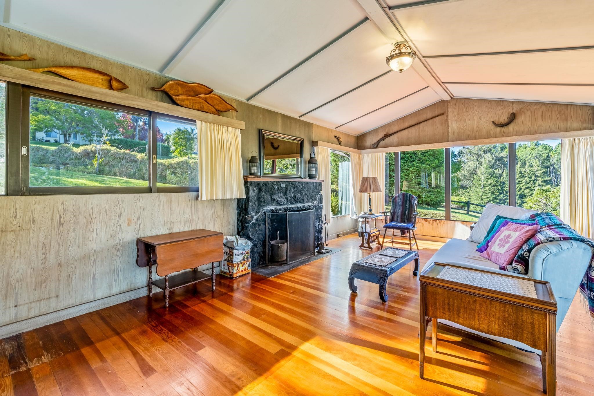 2640 Olinda Road Makawao, HI 96768 - Photo 48 of 49 a living room with fireplace furniture and a floor to ceiling window