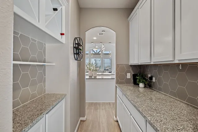 a kitchen with granite countertop a sink and cabinets