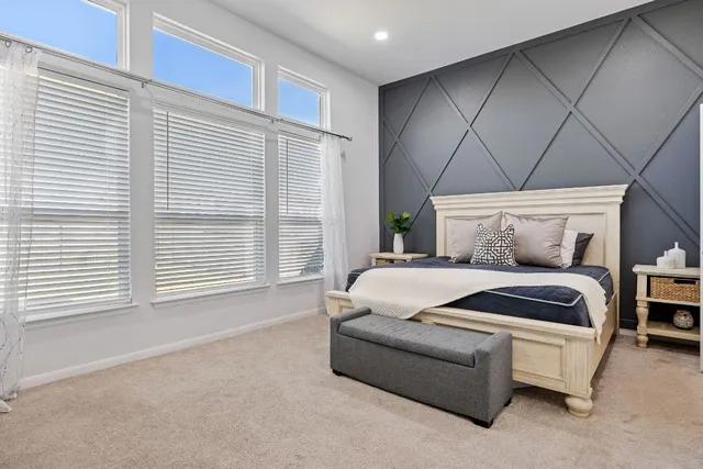 a bedroom with a bed and a couch