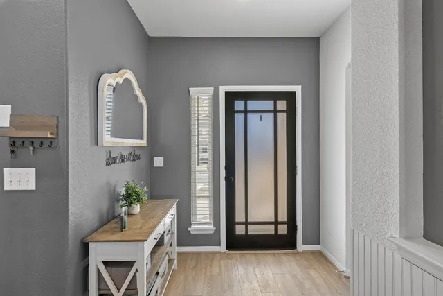 a view of an entryway with wooden floor