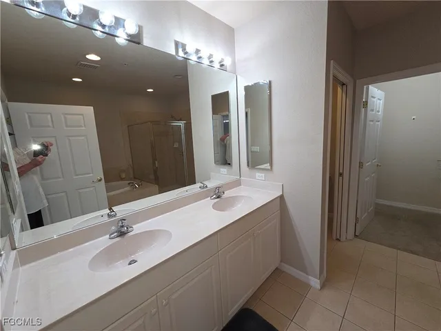 a bathroom with a double vanity sink and a mirror