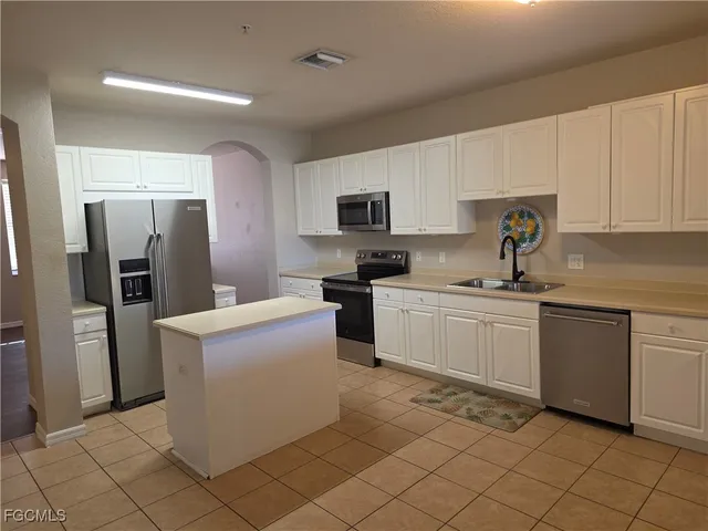 a kitchen with cabinets and stainless steel appliances