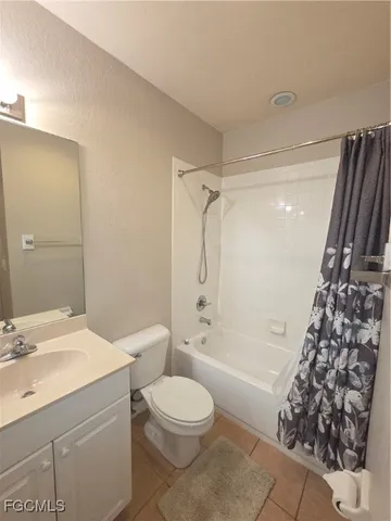 a bathroom with a granite countertop toilet a sink and a bathtub