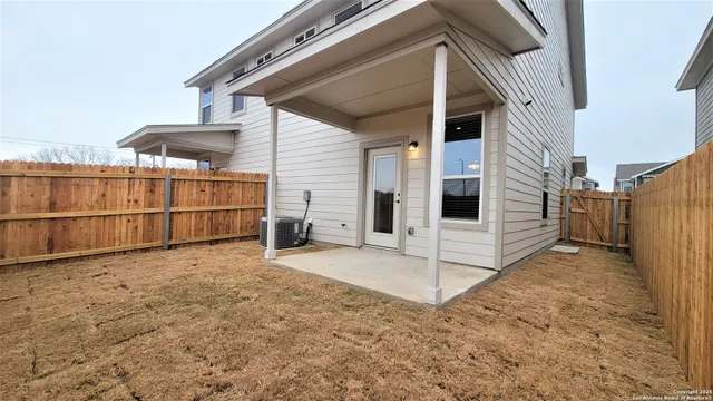 a view of a house with a wooden fence