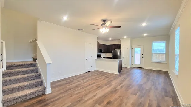 a view of a kitchen with wooden floor and a kitchen