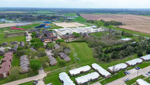 an aerial view of residential houses with outdoor space