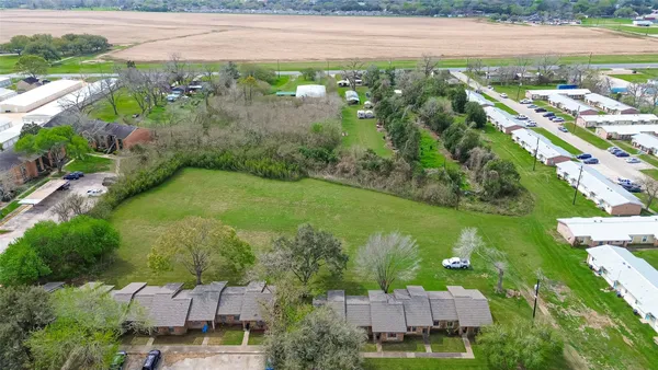 an aerial view of residential houses with outdoor space and river