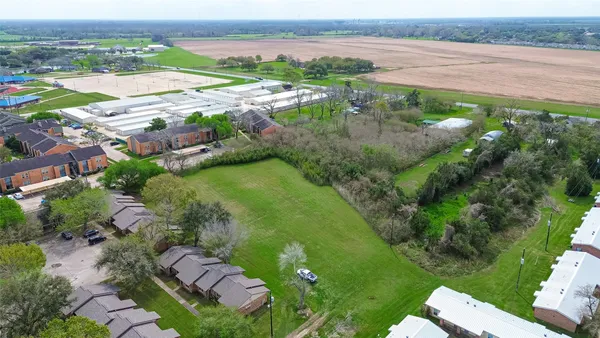 an aerial view of ocean with residential house and outdoor space