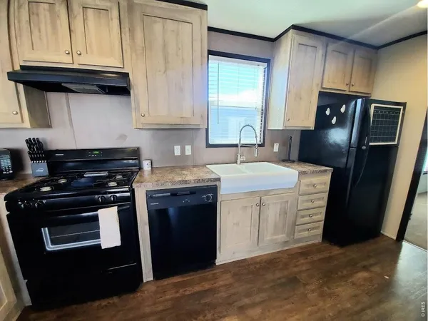 a kitchen with stainless steel appliances granite countertop a stove a refrigerator and a sink