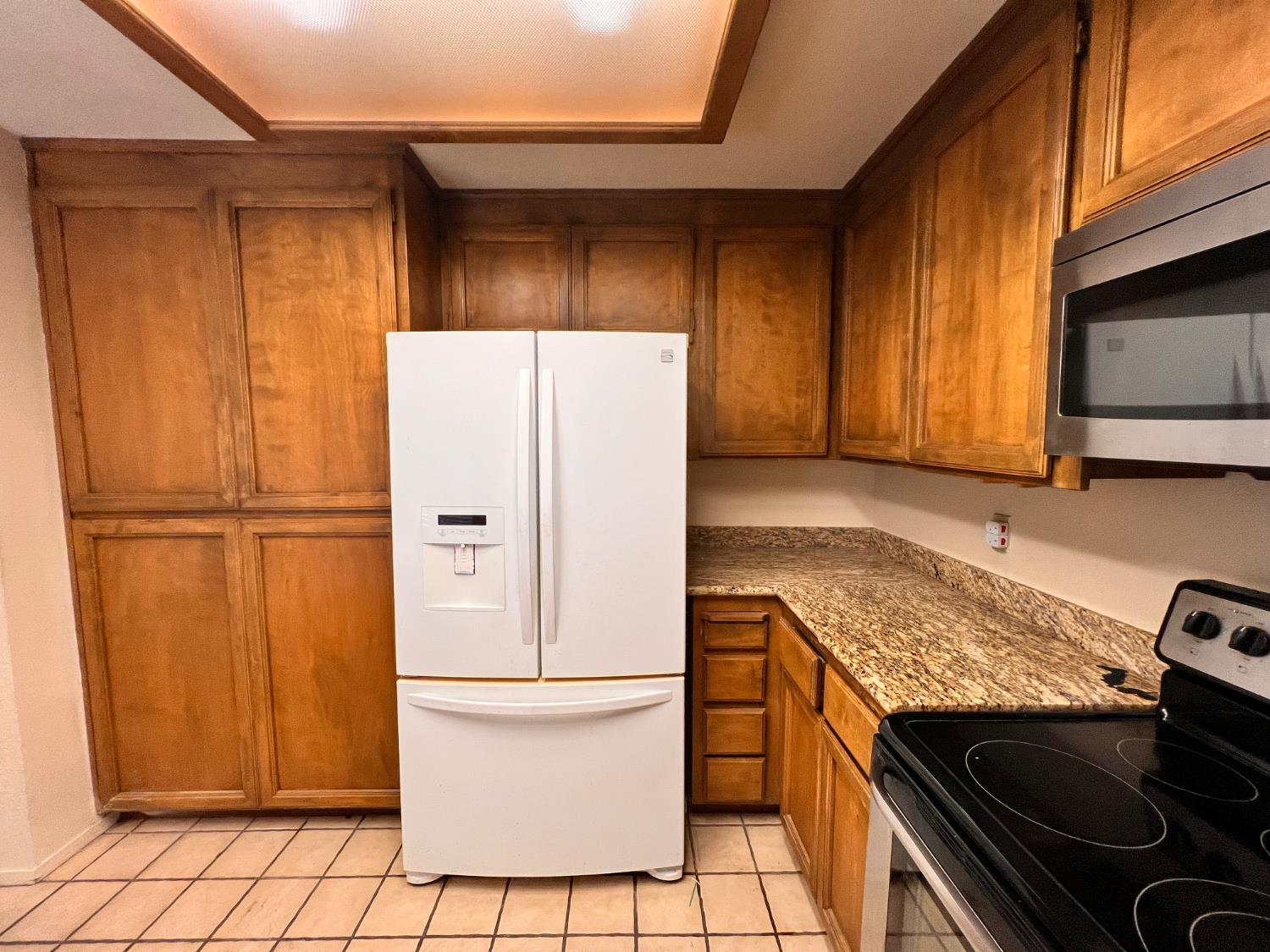 1417 West Swain Road Stockton, CA 95207 - Photo 11 of 18 a kitchen with a stove microwave and refrigerator