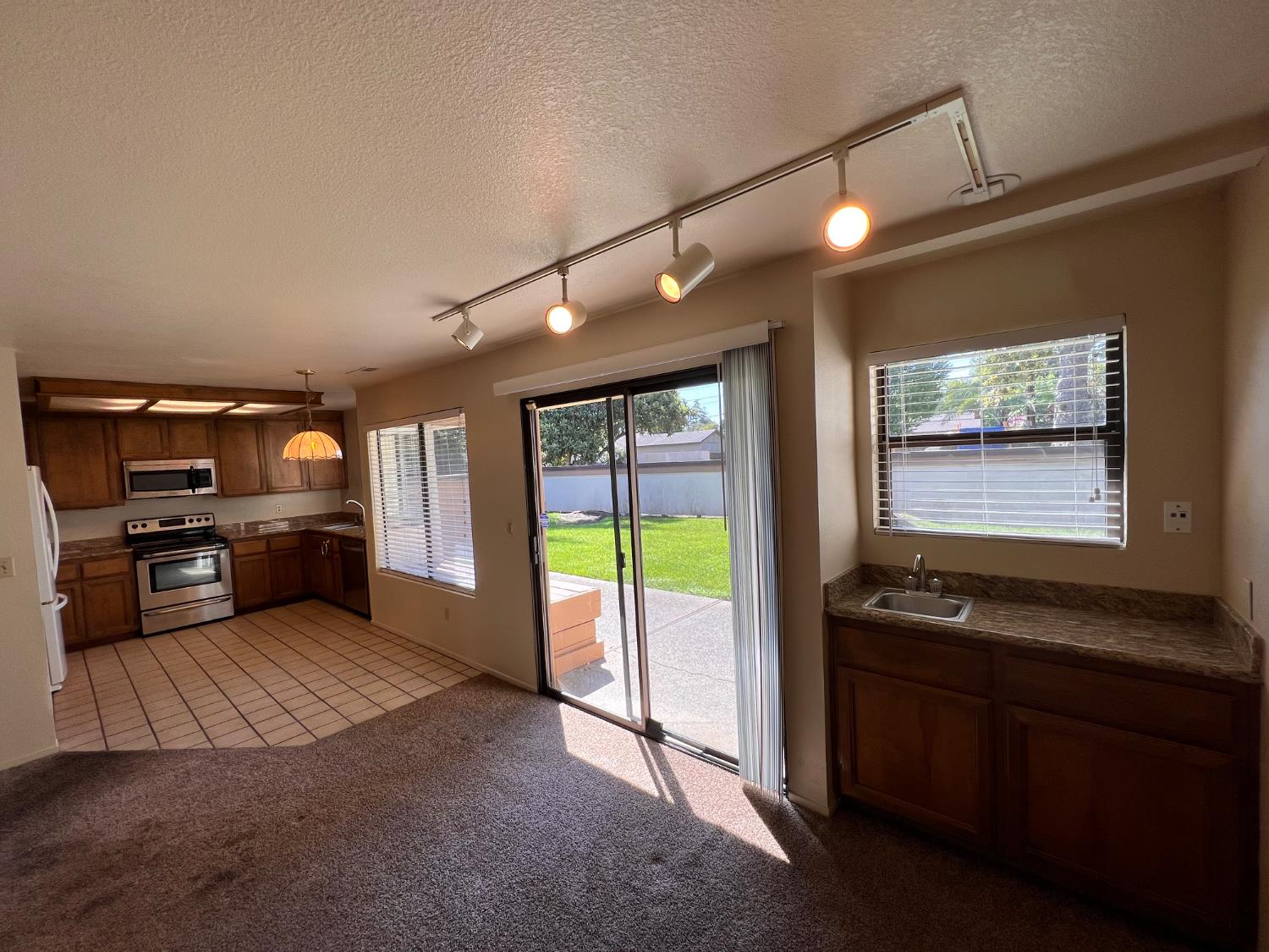 1417 West Swain Road Stockton, CA 95207 - Photo 16 of 29 a view of a living room with furniture and a floor to ceiling window