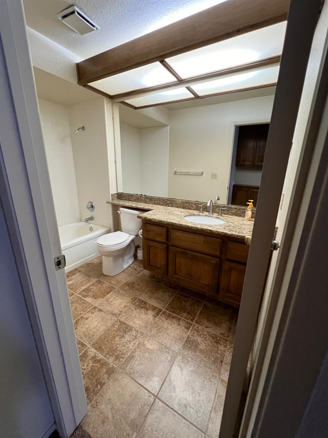 1417 West Swain Road Stockton, CA 95207 - Photo 21 of 29 a bathroom with a sink a toilet and a mirror