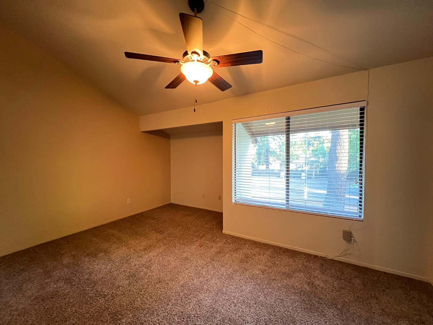 1417 West Swain Road Stockton, CA 95207 - Photo 26 of 29 an empty room with a window and a fan