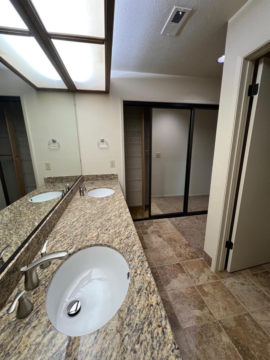 1417 West Swain Road Stockton, CA 95207 - Photo 28 of 29 a bathroom with a sink and a mirror