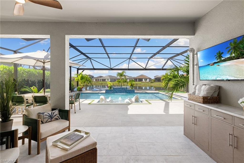 3967 Pegasus Way Naples, FL 34120 - Photo 21 of 50 a living room with stainless steel appliances furniture a chandelier and a large window