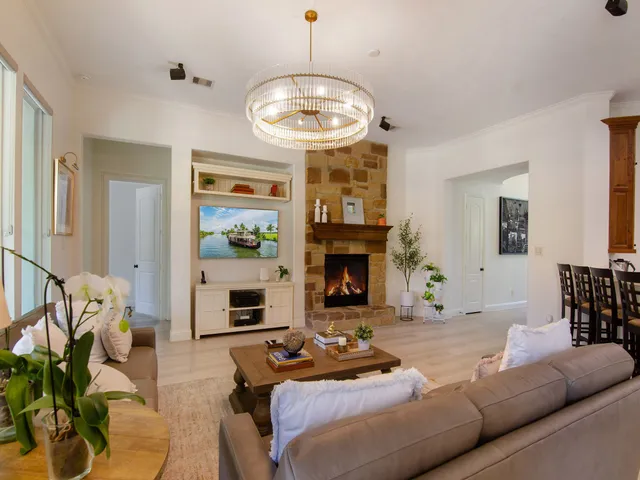 a living room with furniture a fireplace and a large mirror