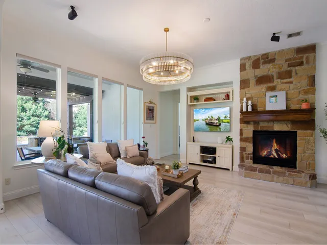 a living room with furniture large window and a fireplace