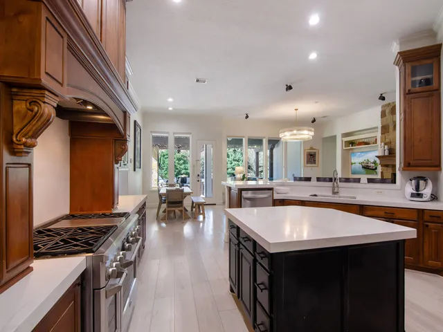 a kitchen with sink stove and chairs