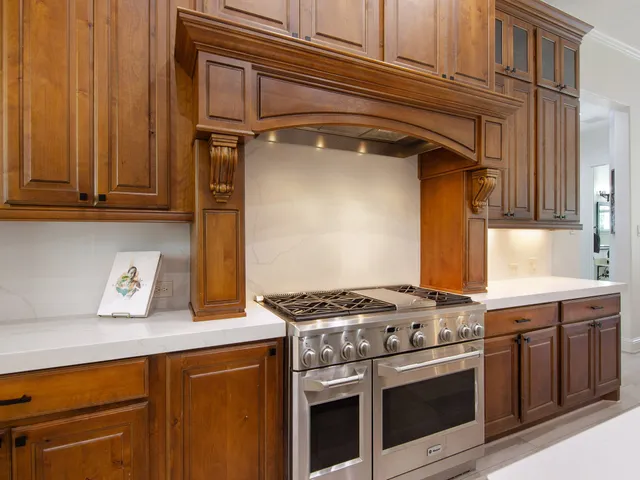 a kitchen with granite countertop a stove and a sink