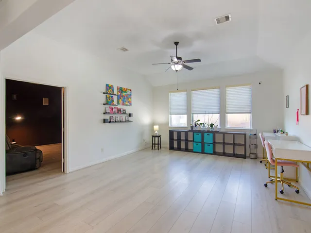 a view of a livingroom with furniture and a ceiling fan