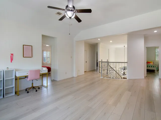 a view of a livingroom with a dining table chairs and couches with wooden floor