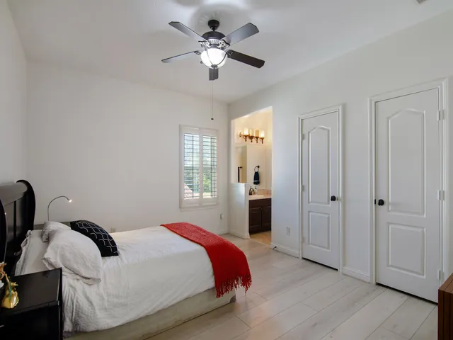 a bedroom with a bed and a chandelier