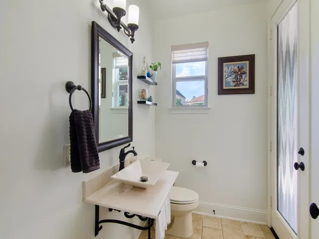 a bathroom with a sink toilet and mirror