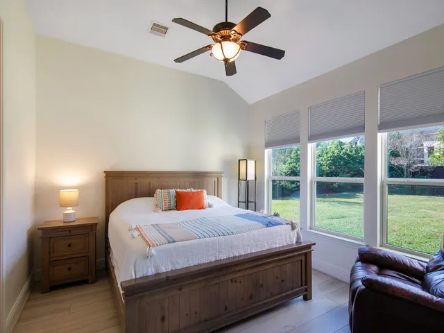 a bedroom with a bed and a large window