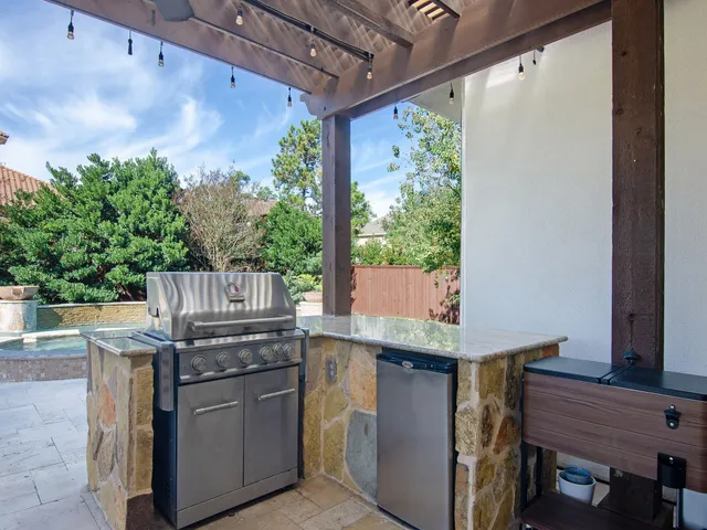 a view of outdoor kitchen with granite countertop lots of counter top space