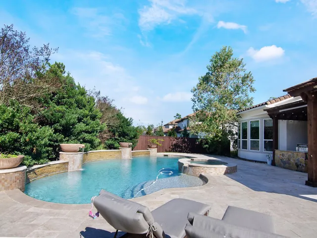 a view of a patio with chairs and potted plants