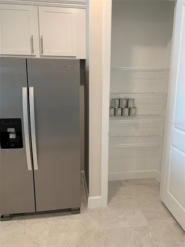 a view of cabinets and refrigerator