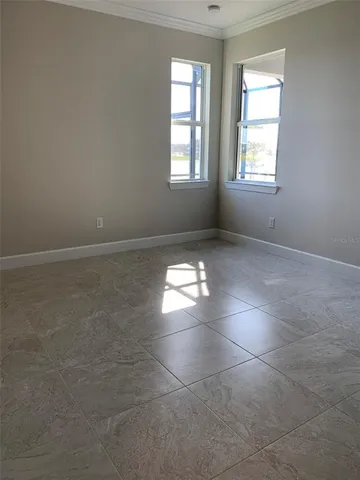an empty room with windows and closet in a room