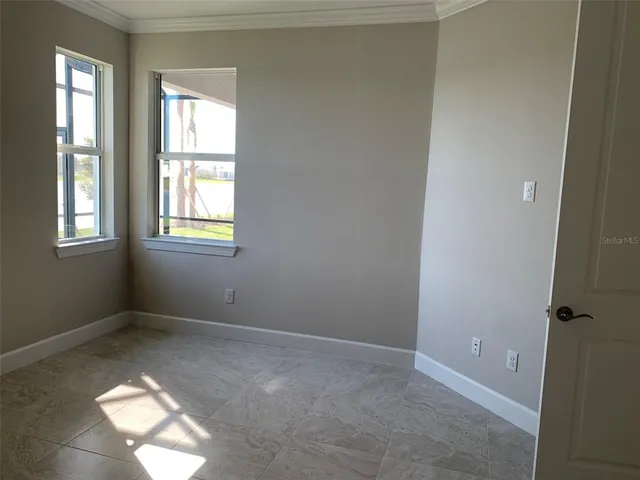 an empty room with windows and closet