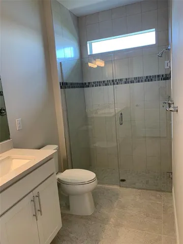 a bathroom with a toilet a sink and shower