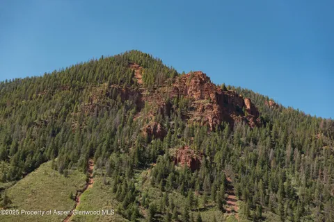 a view of a large building with a mountain in the background