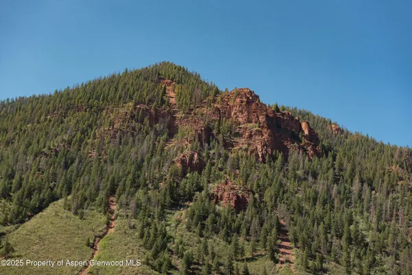 a view of a large building with a mountain in the background
