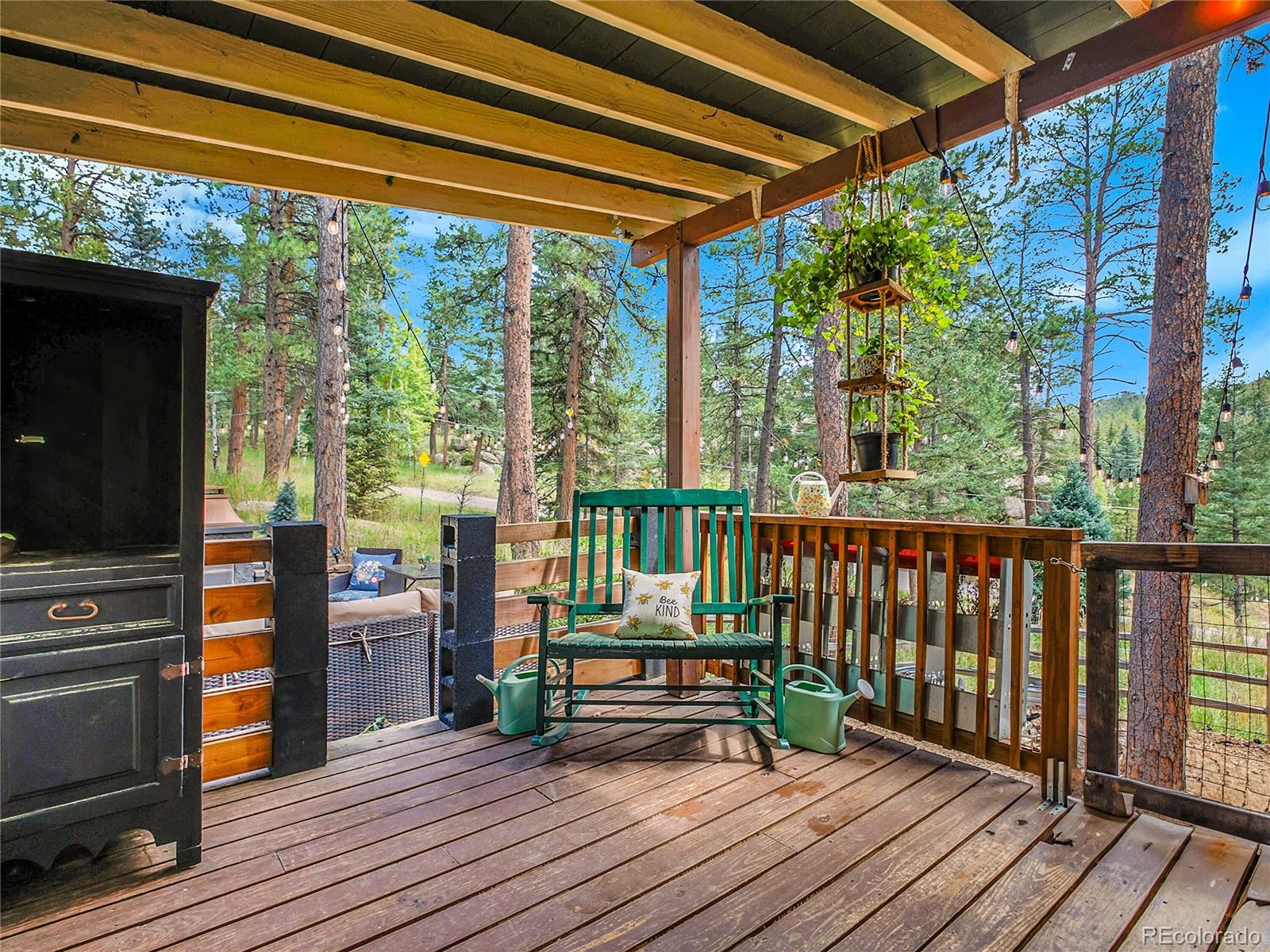 6999 South Columbine Road Evergreen, CO 80439 - Photo 10 of 15 a view of balcony with wooden floor and furniture