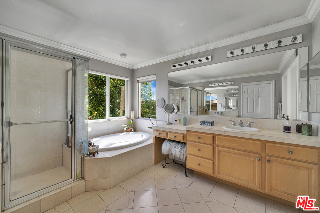 2836 Arbella Lane Thousand Oaks, CA 91362 - Photo 22 of 28 a en suite bathroom with a double vanity sink a mirror and a shower