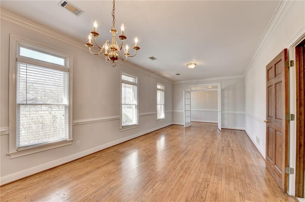 1622 New Hope Road Lawrenceville, GA 30045 - Photo 13 of 110 a view of an empty room with wooden floor and a window