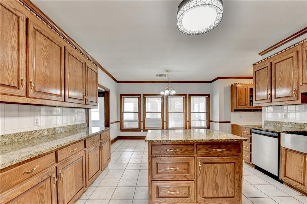 1622 New Hope Road Lawrenceville, GA 30045 - Photo 24 of 110 a kitchen with kitchen island granite countertop a stove a sink and a granite counter tops