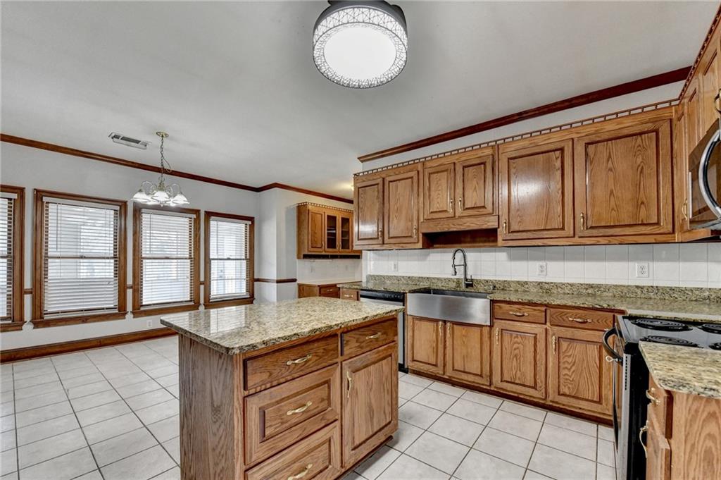 1622 New Hope Road Lawrenceville, GA 30045 - Photo 26 of 110 a kitchen with stainless steel appliances granite countertop a sink stove and cabinets