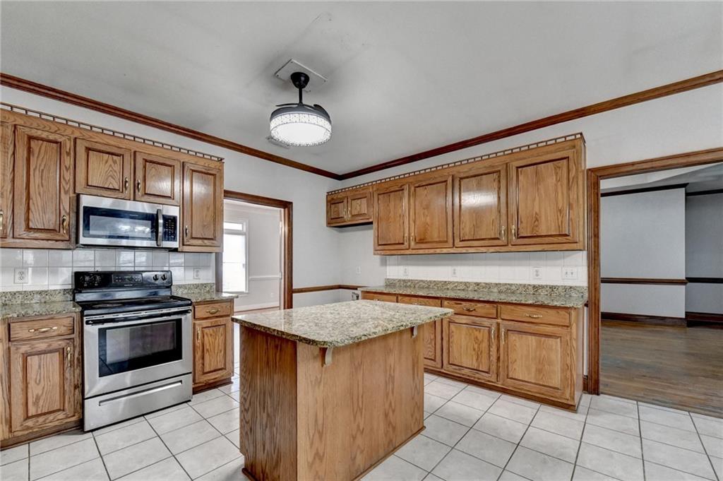 1622 New Hope Road Lawrenceville, GA 30045 - Photo 30 of 110 a kitchen with stainless steel appliances granite countertop a stove a sink and a refrigerator
