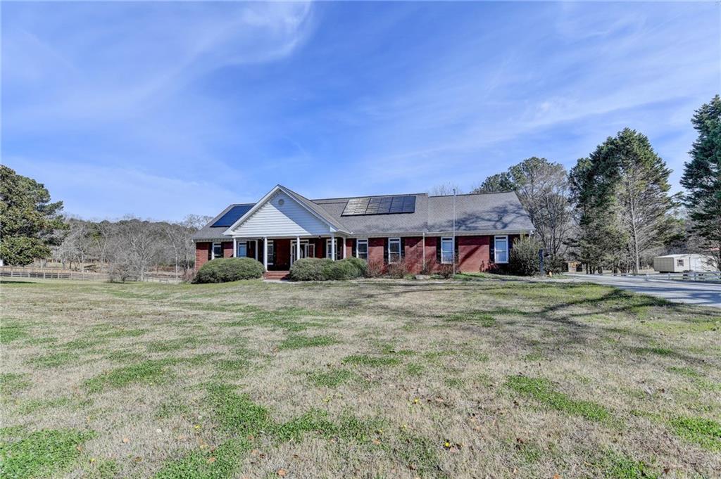 1622 New Hope Road Lawrenceville, GA 30045 - Photo 3 of 110 a view of a house with a big yard and large tree