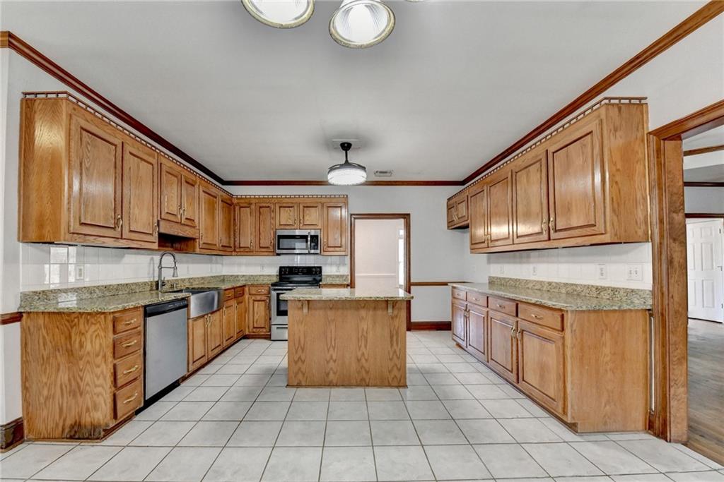1622 New Hope Road Lawrenceville, GA 30045 - Photo 36 of 110 a kitchen with stainless steel appliances granite countertop a sink and cabinets