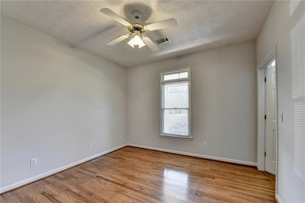 1622 New Hope Road Lawrenceville, GA 30045 - Photo 42 of 110 an empty room with wooden floor and windows